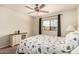 Comfortable bedroom with a bright window view, stylish dresser, and neutral decor at 10940 E Olla Ave, Mesa, AZ 85212