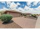 Charming home featuring a large driveway, desert landscaping, and a two-car garage at 10940 E Olla Ave, Mesa, AZ 85212