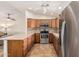 This U-shaped kitchen features stainless steel appliances and natural wood cabinets at 10940 E Olla Ave, Mesa, AZ 85212
