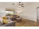 Comfortable living room featuring neutral sofas with yellow pillows and backyard view at 10940 E Olla Ave, Mesa, AZ 85212
