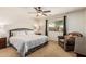 Comfortable bedroom features a ceiling fan, and a beautiful backyard view at 10940 E Olla Ave, Mesa, AZ 85212