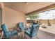 Cozy covered patio features brick floors, comfortable seating, and views of the desert landscape at 10940 E Olla Ave, Mesa, AZ 85212