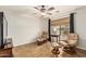 Bright sitting room featuring neutral walls, tile floors, comfortable seating, and a window at 10940 E Olla Ave, Mesa, AZ 85212