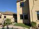 Backyard featuring artificial turf, mature landscaping, and a view of the home's exterior, ideal for outdoor enjoyment at 1128 E Phelps St, Gilbert, AZ 85295