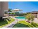 Backyard view featuring a pool, artificial turf, patio, and comfortable seating, ideal for outdoor entertaining at 1128 E Phelps St, Gilbert, AZ 85295