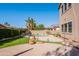Inviting backyard featuring a sparkling pool, lush green artificial turf, and patio area perfect for outdoor gatherings at 1128 E Phelps St, Gilbert, AZ 85295