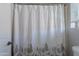 Close-up of bathroom shower curtain with a gray forest and deer design at 1128 E Phelps St, Gilbert, AZ 85295