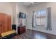 Bright bedroom with wood floors, a wall-mounted TV, closet, dresser, and natural light from the window at 1128 E Phelps St, Gilbert, AZ 85295