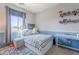 Cozy bedroom with large window, comfortable bed, and display shelves at 1128 E Phelps St, Gilbert, AZ 85295