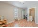 Bonus room featuring wood floors, a stationary bike, and a small wooden side table at 1128 E Phelps St, Gilbert, AZ 85295