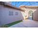 Enclosed courtyard is beautifully decorated with decorative wall art, string lights and an archway at 1128 E Phelps St, Gilbert, AZ 85295