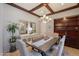 Dining room featuring a chandelier, seating for six, wood beams and built-in storage at 1128 E Phelps St, Gilbert, AZ 85295