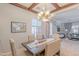 Dining room featuring a wood table with seating for six, a chandelier, and a large window at 1128 E Phelps St, Gilbert, AZ 85295