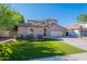 Charming home with a three-car garage, lush green grass, and meticulous landscaping in a desirable neighborhood at 1128 E Phelps St, Gilbert, AZ 85295