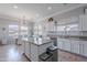Bright kitchen with an island, stainless steel appliances, and dining area with lots of natural light at 1128 E Phelps St, Gilbert, AZ 85295