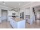 Bright kitchen with white cabinets, stainless appliances, an island, and granite countertops at 1128 E Phelps St, Gilbert, AZ 85295
