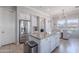 Kitchen featuring white cabinets, stainless appliances and center island with granite countertops at 1128 E Phelps St, Gilbert, AZ 85295