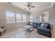 Bright living room featuring tile flooring and large windows at 1128 E Phelps St, Gilbert, AZ 85295