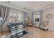 Cozy living room showcasing a tufted sofa, neutral armchairs, light gray curtains, and ceramic tile flooring at 1128 E Phelps St, Gilbert, AZ 85295
