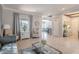 Open-concept living space with tile floors, neutral walls, stylish furniture, and an open view to the staircase at 1128 E Phelps St, Gilbert, AZ 85295