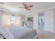Bright bedroom featuring a dresser, ceiling fan, and sliding doors to another room at 1128 E Phelps St, Gilbert, AZ 85295
