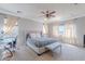 Bright main bedroom with a ceiling fan, neutral colors, and a work space area at 1128 E Phelps St, Gilbert, AZ 85295