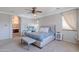 Spacious bedroom with a large bed, ceiling fan, and an en suite bathroom at 1128 E Phelps St, Gilbert, AZ 85295