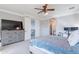 Bright bedroom featuring a dresser, ceiling fan, and doorway leading to a stairwell at 1128 E Phelps St, Gilbert, AZ 85295