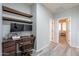 Bright home office featuring a desk, two floating shelves, and wood flooring at 1128 E Phelps St, Gilbert, AZ 85295