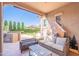 Covered patio with outdoor kitchen, seating, and manicured backyard at 1128 E Phelps St, Gilbert, AZ 85295