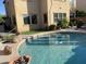 Backyard pool area featuring a refreshing pool, a small patio, artificial turf, and access to the home's exterior at 1128 E Phelps St, Gilbert, AZ 85295