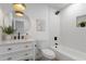 Modern bathroom with white vanity, a round mirror, and a shower-over-tub combo at 1205 W 7Th St, Tempe, AZ 85281