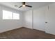 Bright bedroom with a ceiling fan, closet with sliding doors, and a large window at 1205 W 7Th St, Tempe, AZ 85281