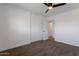 Carpeted bedroom featuring a ceiling fan, closet with sliding doors, and a view into the ensuite bathroom at 1205 W 7Th St, Tempe, AZ 85281