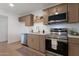 Modern kitchen featuring stainless steel appliances, stylish cabinets, and light countertops at 1205 W 7Th St, Tempe, AZ 85281