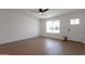 Living room boasts hardwood floors, ceiling fan and a large window at 1205 W 7Th St, Tempe, AZ 85281