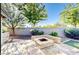 Backyard features an outdoor fire pit with built-in seating, desert landscaping, and a synthetic grass area at 13280 W Caribbean Ln, Surprise, AZ 85379