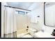 Bright bathroom featuring a shower-tub combo with a modern shower curtain at 13280 W Caribbean Ln, Surprise, AZ 85379