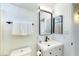 Well-lit bathroom with white vanity, modern fixtures, and sleek mirror at 13280 W Caribbean Ln, Surprise, AZ 85379
