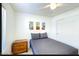 Neutral bedroom featuring a bed, wooden nightstand, and artwork on the wall at 13280 W Caribbean Ln, Surprise, AZ 85379