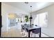 Bright dining area featuring tiled floors and a stylish pendant light above the dining table at 13280 W Caribbean Ln, Surprise, AZ 85379