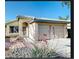 Charming single-story home with a well-manicured front yard and a two-car garage, and covered entry way at 13280 W Caribbean Ln, Surprise, AZ 85379