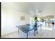 Spacious game room featuring a ping pong table with open access to other areas at 13280 W Caribbean Ln, Surprise, AZ 85379