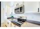 Modern kitchen featuring stainless steel appliances, sleek countertops, and white cabinetry providing style and functionality at 13280 W Caribbean Ln, Surprise, AZ 85379