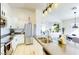 Open-concept kitchen boasts white cabinetry, stainless steel appliances, kitchen island, and pendant lighting at 13280 W Caribbean Ln, Surprise, AZ 85379