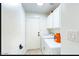 Bright laundry room equipped with washer, dryer, and storage cabinets above at 13280 W Caribbean Ln, Surprise, AZ 85379