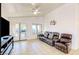 Bright living room featuring a leather sofa and access to the outdoors at 13280 W Caribbean Ln, Surprise, AZ 85379