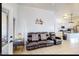 Inviting living room area with a leather sofa and an open kitchen view at 13280 W Caribbean Ln, Surprise, AZ 85379
