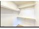 A bright, clean, walk-in closet with shelves, offering ample storage space at 13280 W Caribbean Ln, Surprise, AZ 85379