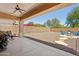 Spacious backyard featuring a covered patio, gravel landscaping, and a fire pit area at 13724 W Luke Ave, Litchfield Park, AZ 85340